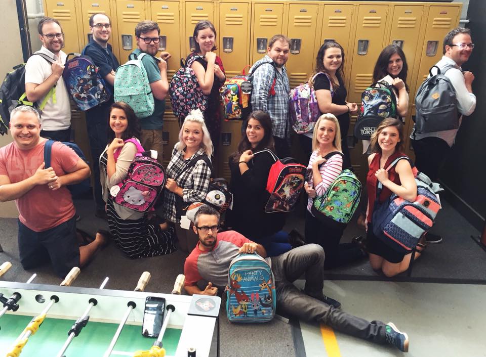 Westwerk team showing off the backpacks filled with school supplies